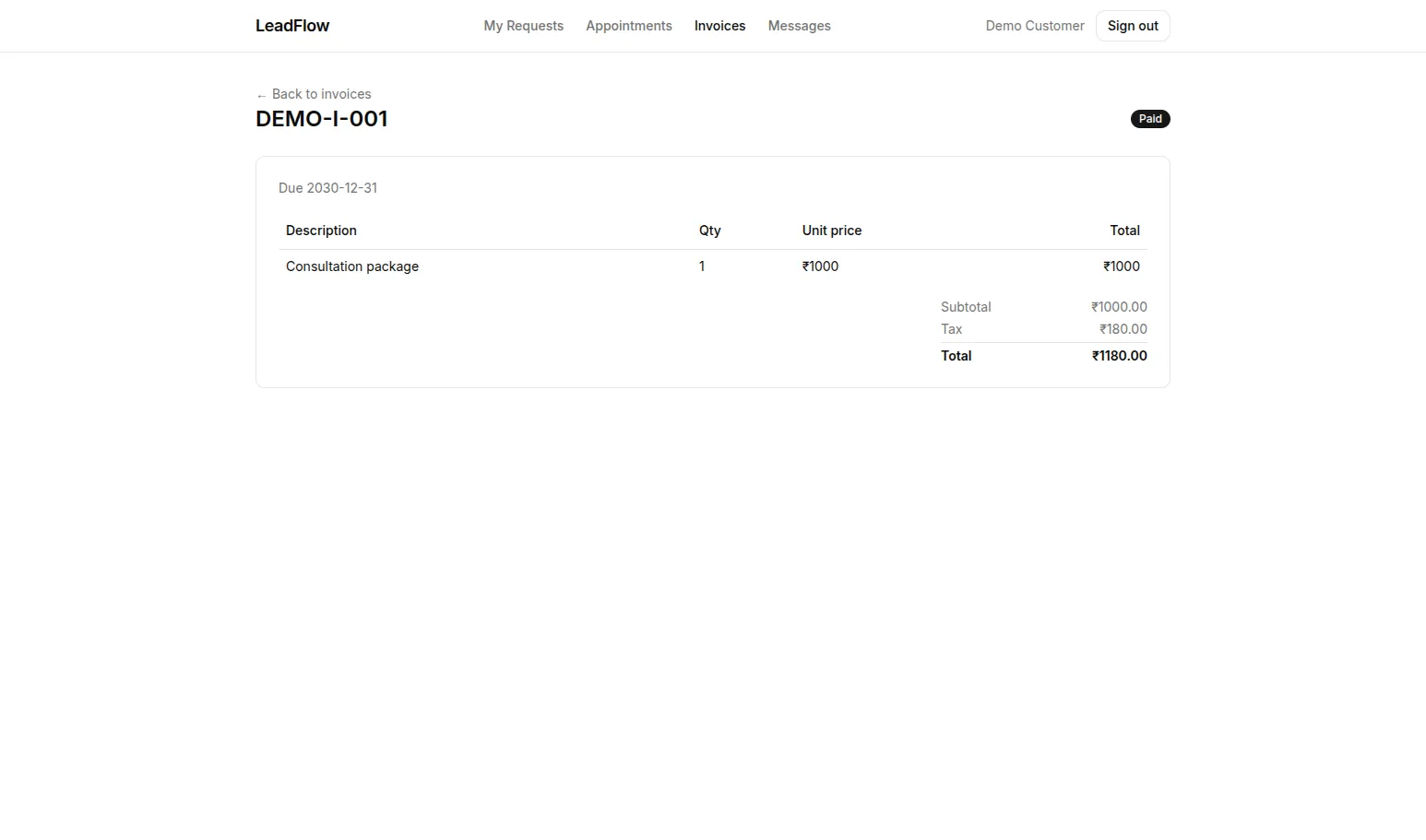 Customer portal invoice marked Paid, showing line items, tax and total.